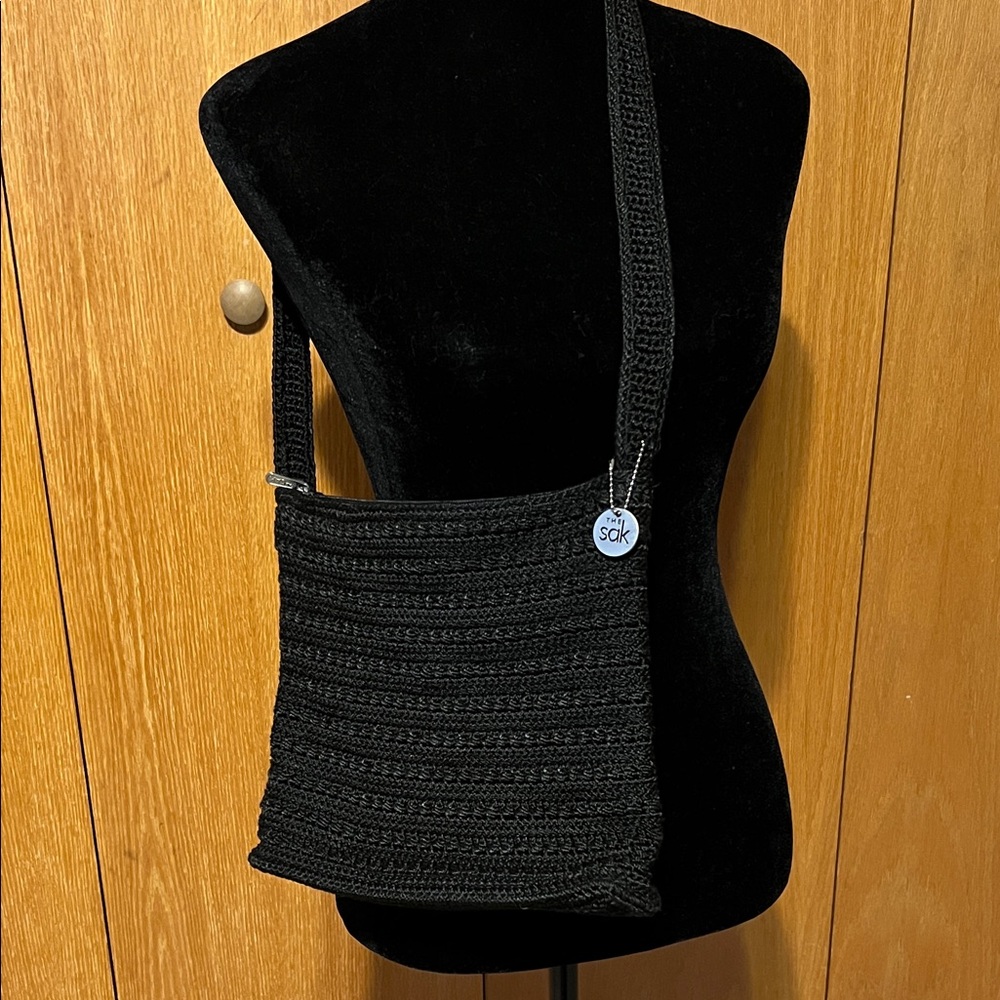 The Sak black, crocheted bag, 9x9“, Good cond. Shoulder strap is 24 in.